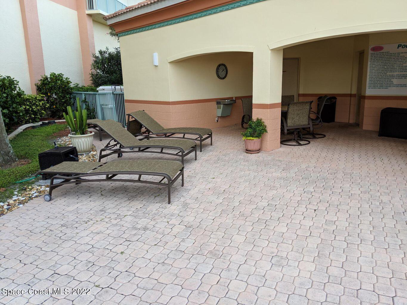 100 Riverside Drive, Unit 702 Cocoa, FL 32922 - Photo 24 of 33 a view of a patio with a table and chairs in patio