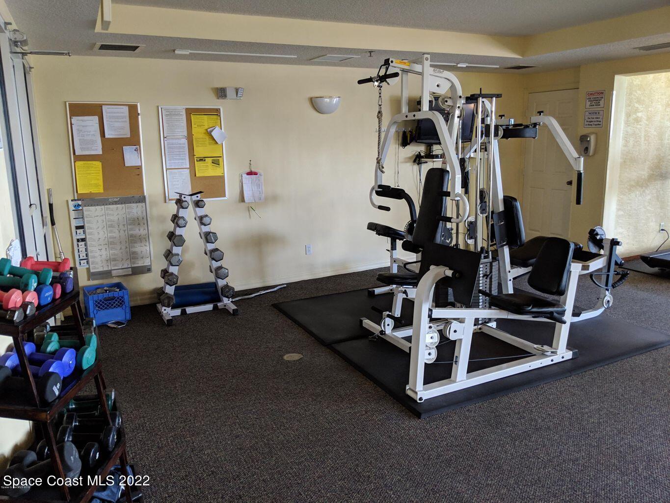 100 Riverside Drive, Unit 702 Cocoa, FL 32922 - Photo 32 of 33 a room with gym equipment and a table