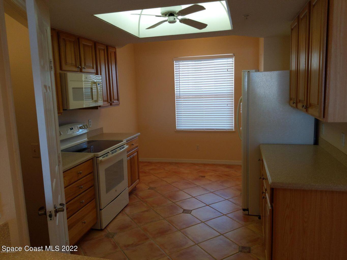 100 Riverside Drive, Unit 702 Cocoa, FL 32922 - Photo 5 of 33 a kitchen with stainless steel appliances granite countertop a refrigerator and a stove