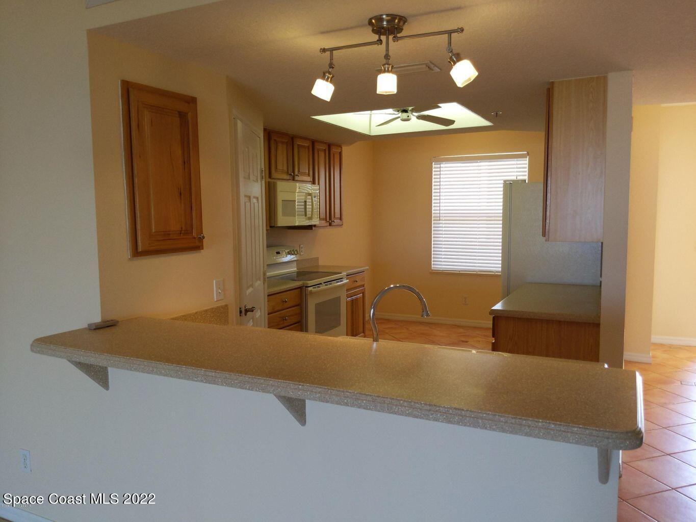 100 Riverside Drive, Unit 702 Cocoa, FL 32922 - Photo 7 of 33 a kitchen with a refrigerator and sink