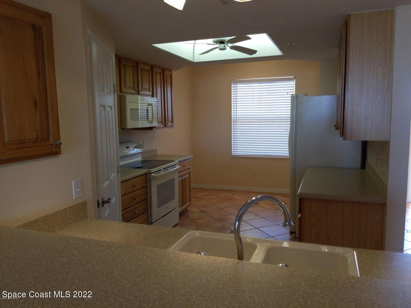 100 Riverside Drive, Unit 702 Cocoa, FL 32922 - Photo 8 of 33 a kitchen with stainless steel appliances granite countertop a stove top oven a sink and dishwasher