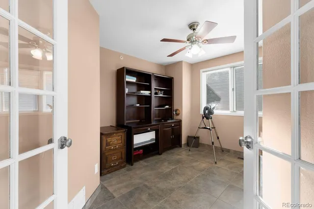 a view of a hallway with workspace and a window