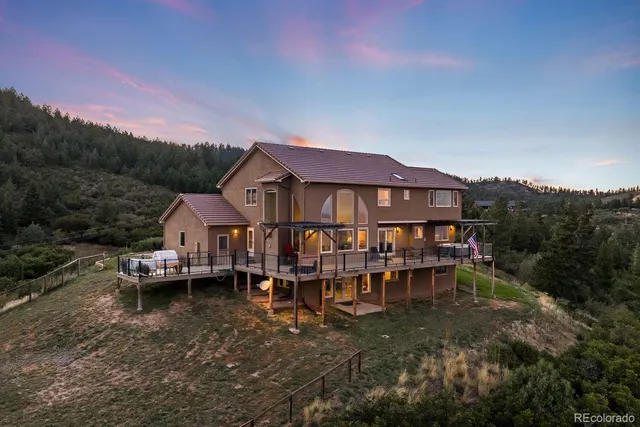 a view of a house with a yard and sitting area