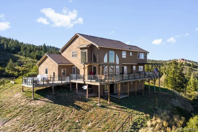 a view of a house with pool and sitting area