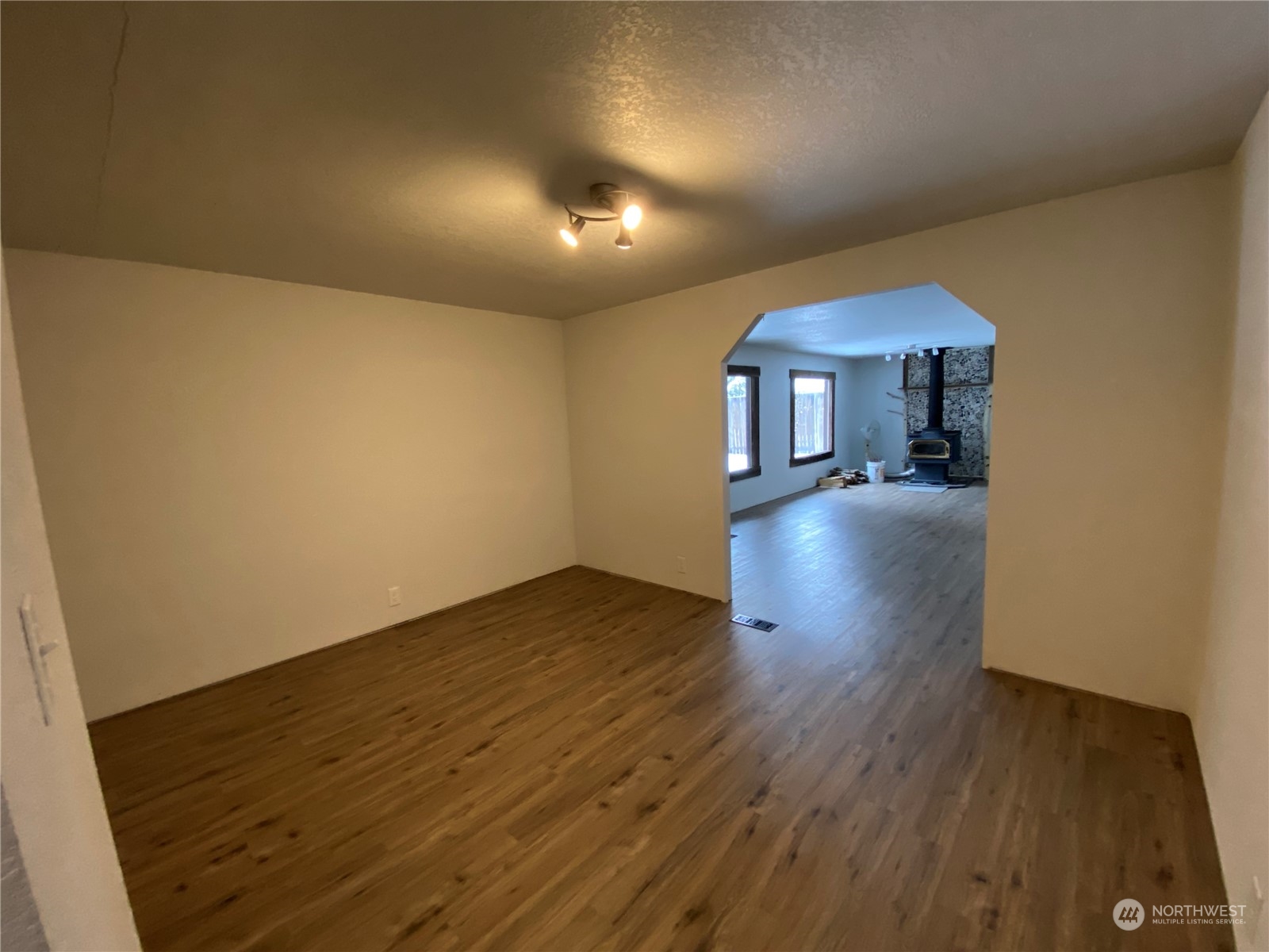 114 Twisp River Road Twisp, WA 98856 - Photo 13 of 35 wooden floor in an empty room with a window
