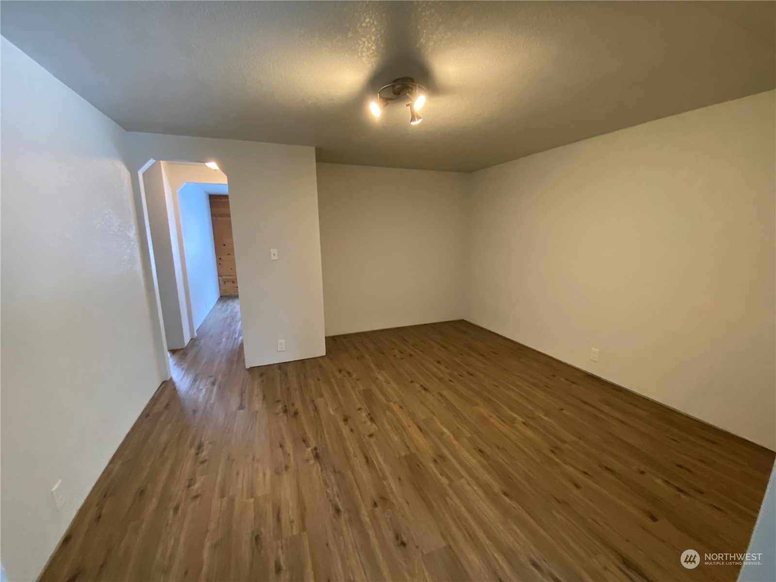 114 Twisp River Road Twisp, WA 98856 - Photo 14 of 35 an empty room with wooden floor and stairs