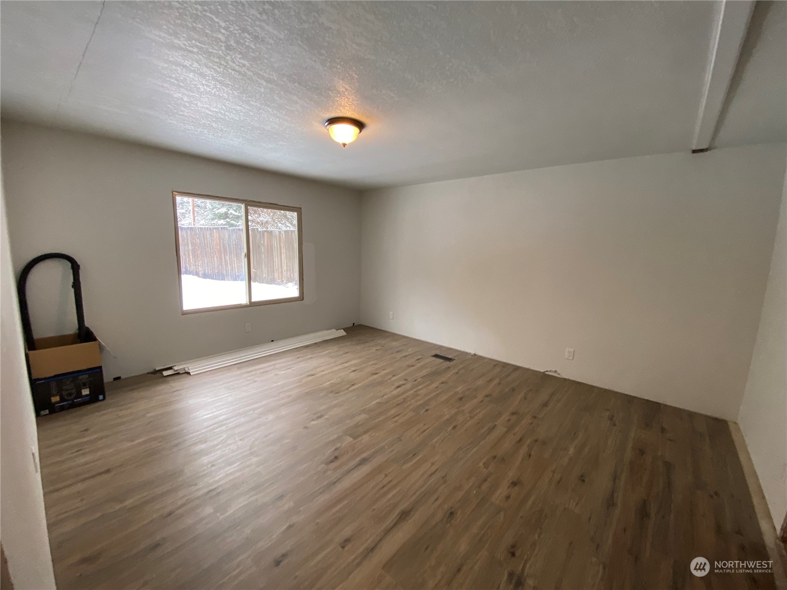 114 Twisp River Road Twisp, WA 98856 - Photo 15 of 35 an empty room with wooden floor and windows