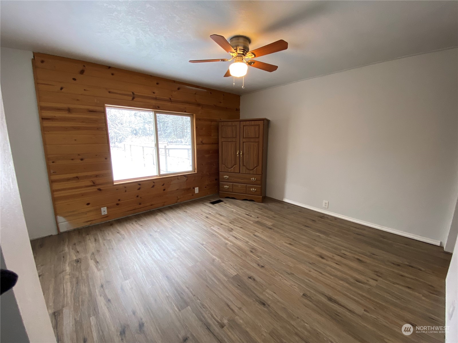 114 Twisp River Road Twisp, WA 98856 - Photo 19 of 35 an empty room with wooden floor and windows