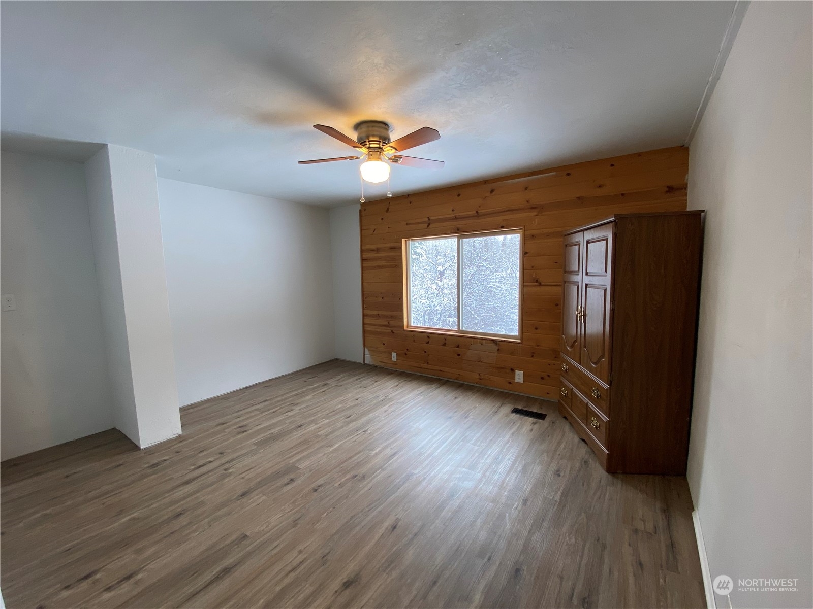 114 Twisp River Road Twisp, WA 98856 - Photo 20 of 35 an empty room with wooden floor and windows