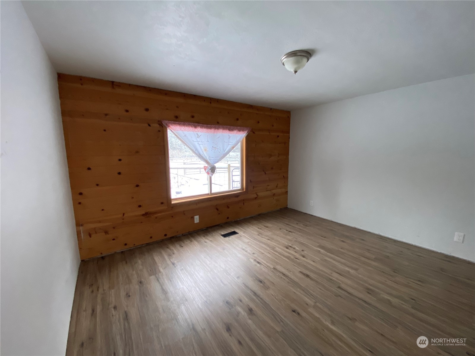 114 Twisp River Road Twisp, WA 98856 - Photo 22 of 35 a view of empty room with wooden floor and fan