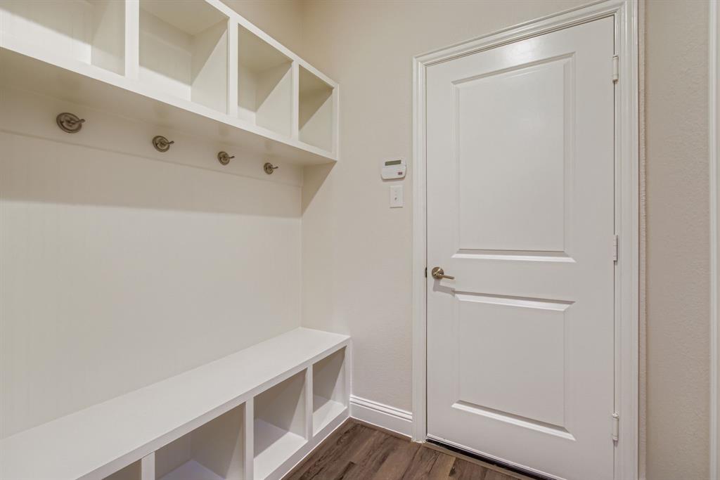 312 Magnolia Drive Oak Point, TX 75068 - Photo 23 of 28 Mudroom featuring dark wood-style floors and baseboards