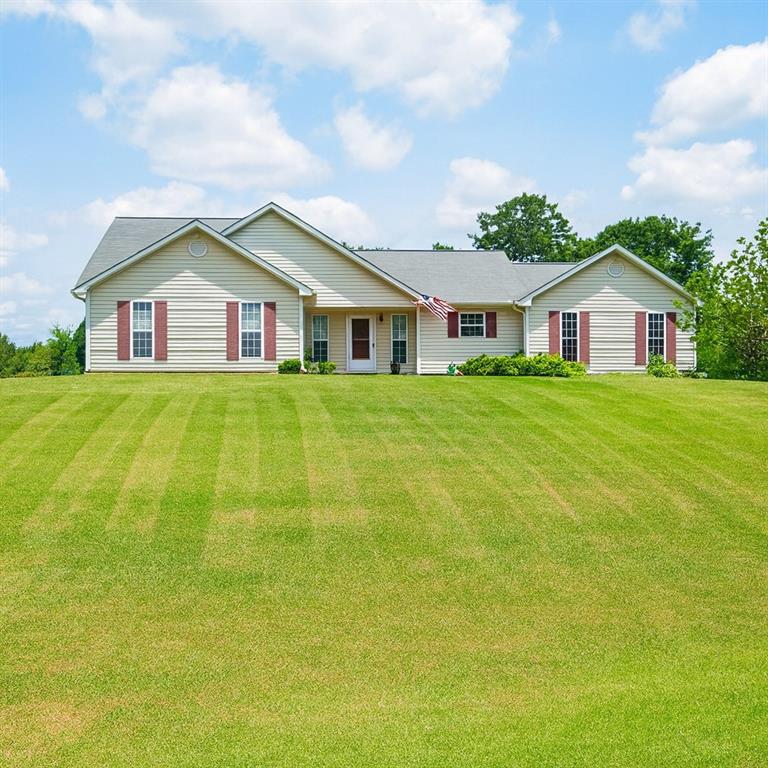 a big house with a big yard and large trees