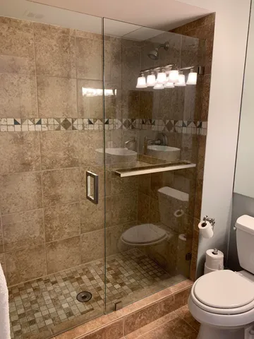 a bathroom with a toilet and a shower