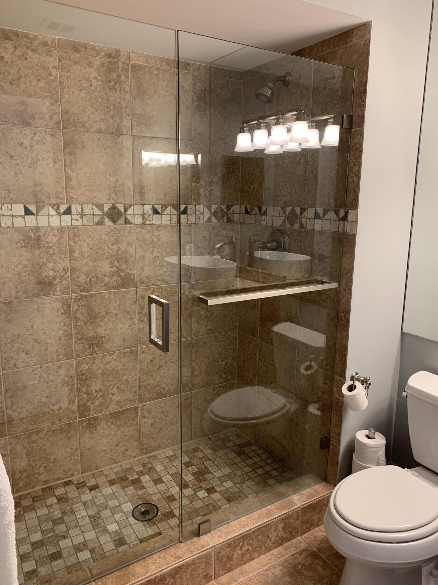 3604 South Ocean Boulevard, Unit 101 Highland Beach, FL 33487 - Photo 15 of 36 a bathroom with a toilet and a shower