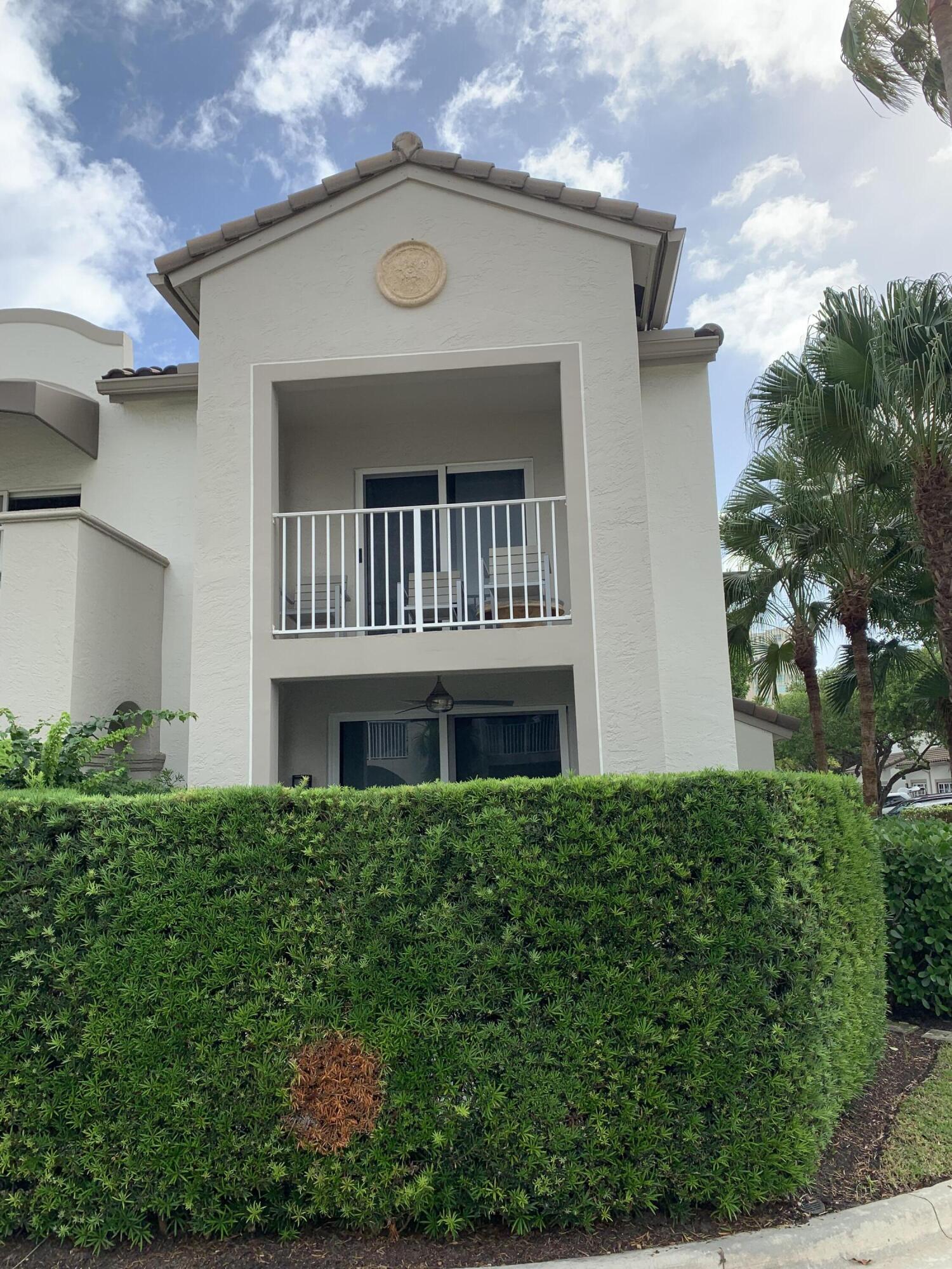 3604 South Ocean Boulevard, Unit 101 Highland Beach, FL 33487 - Photo 18 of 36 a front view of a house with a yard