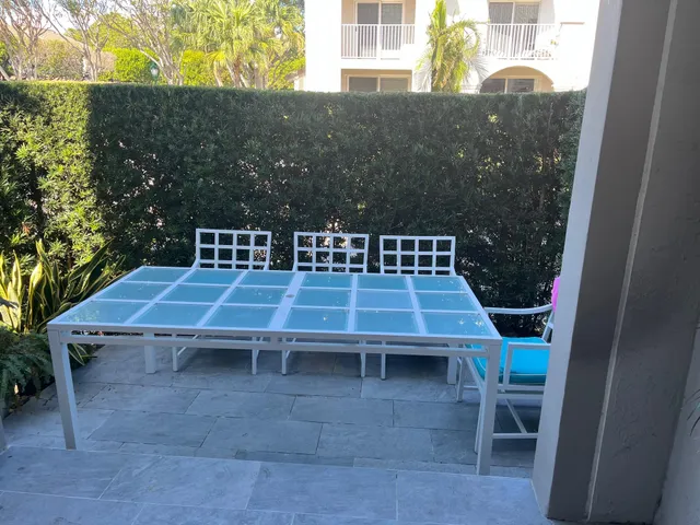 a view of a wooden chairs and table in the terrace