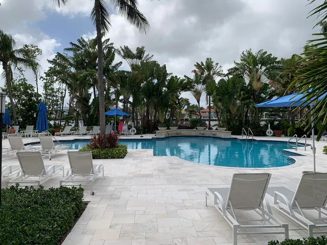 a view of a patio with swimming pool and a chairs