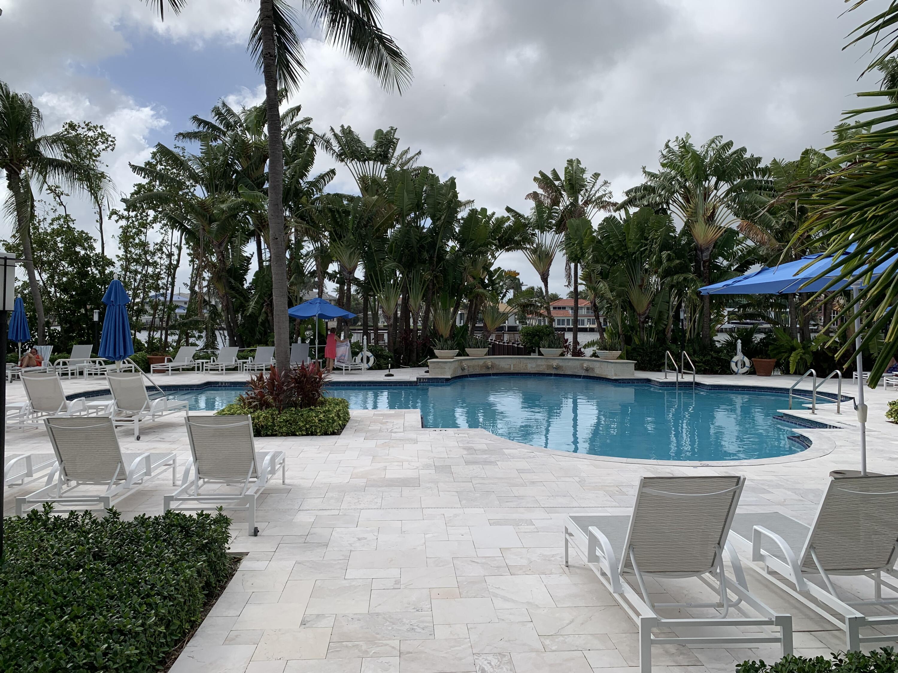3604 South Ocean Boulevard, Unit 101 Highland Beach, FL 33487 - Photo 25 of 36 a view of a patio with swimming pool and a chairs