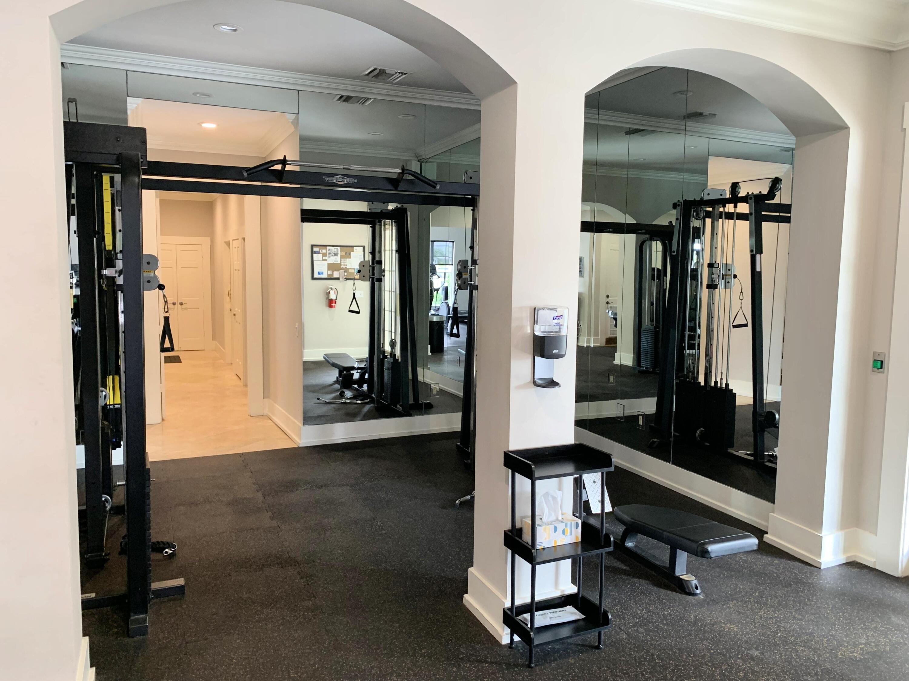 3604 South Ocean Boulevard, Unit 101 Highland Beach, FL 33487 - Photo 29 of 36 a room with gym equipment and a mirror