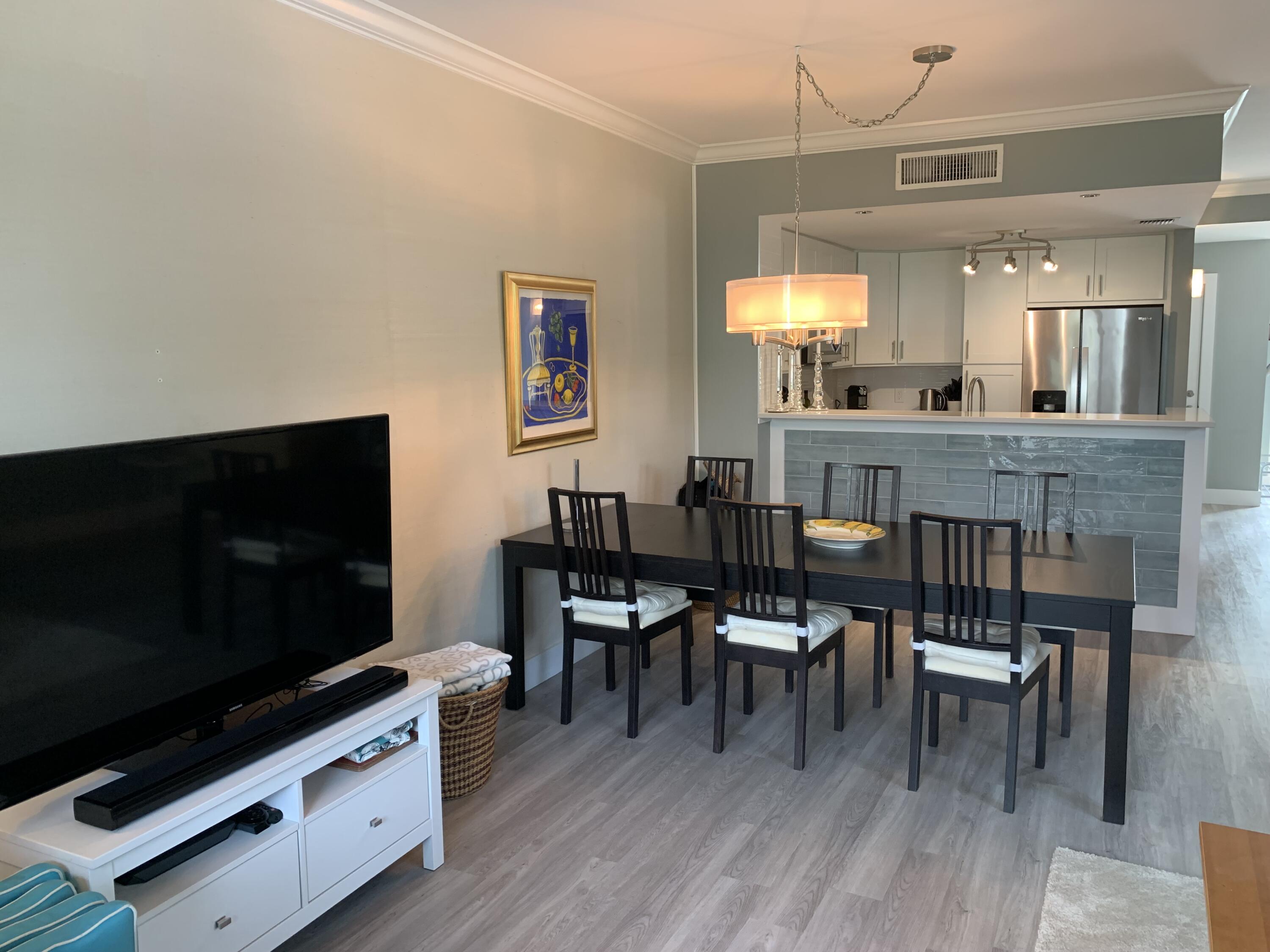 3604 South Ocean Boulevard, Unit 101 Highland Beach, FL 33487 - Photo 3 of 36 a view of a dining room with furniture and wooden floor