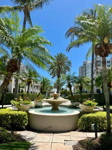 a view of swimming pool with lawn chairs and plants