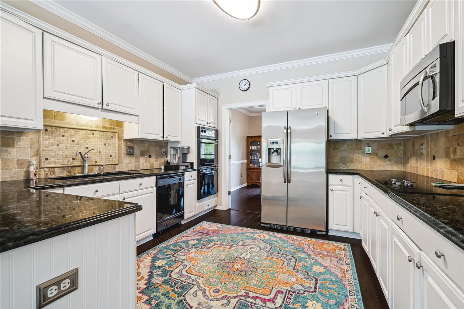 1489 John Ridge Drive Collierville, TN 38017 - Photo 16 of 39 a kitchen with granite countertop a refrigerator sink and cabinets
