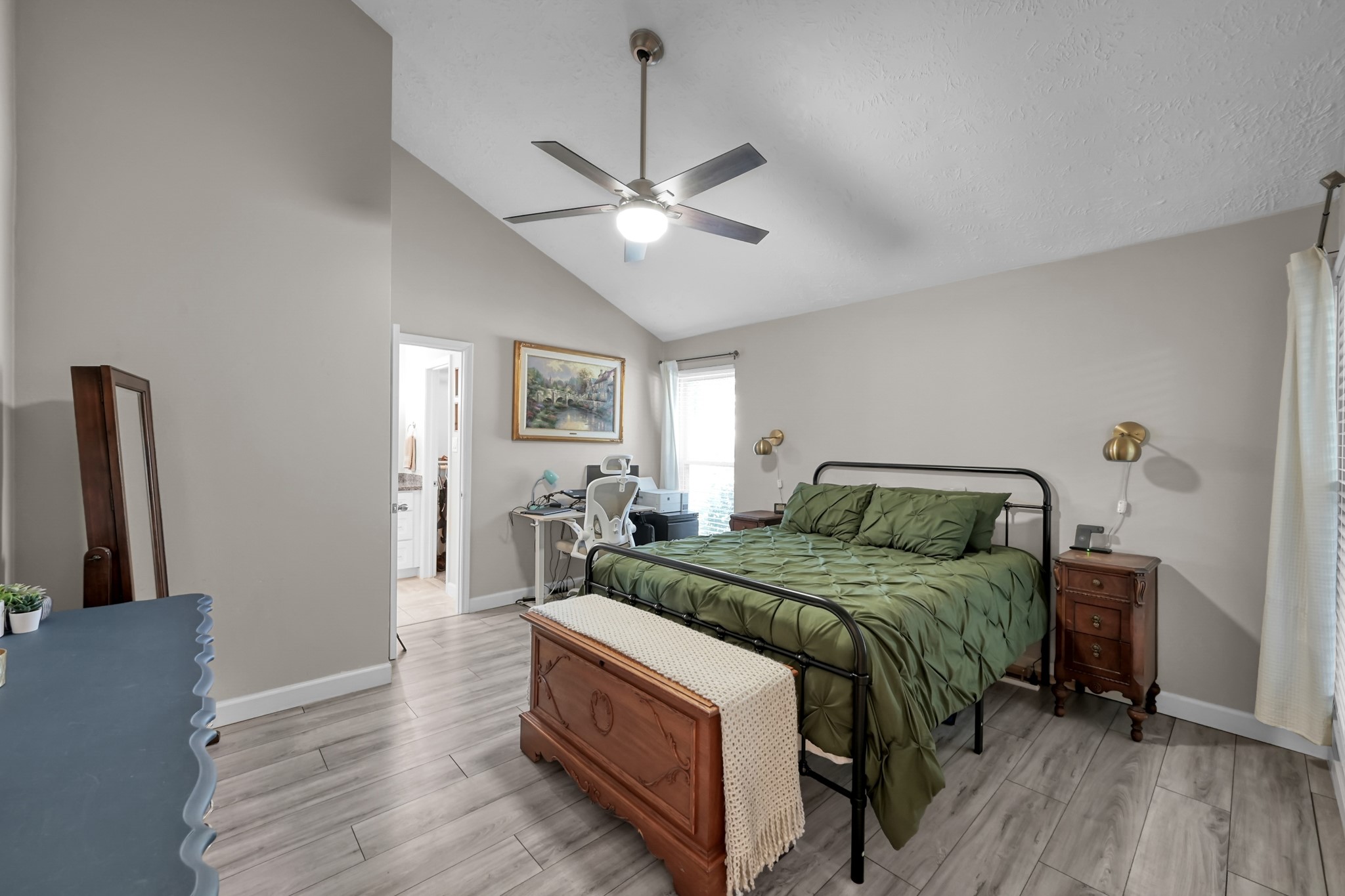 17323 Lowick Street Spring, TX 77379 - Photo 9 of 21 Spacious primary bedroom with wood look flooring.