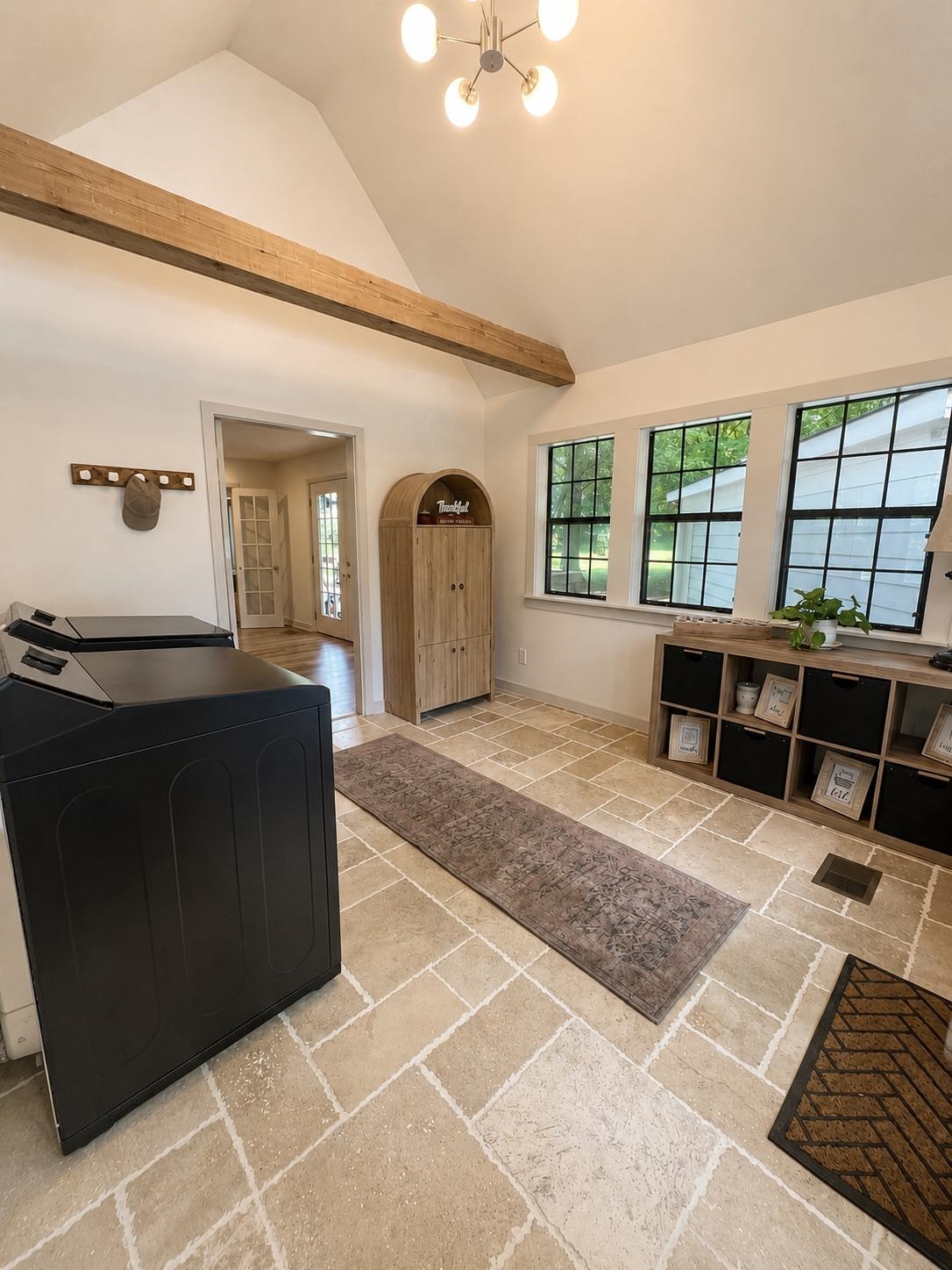 470 Rich Road Somerville, TN 38068 - Photo 15 of 40 Vaulted ceiling featuring an exposed beam, a modern chandelier, and ample natural light from multiple windows