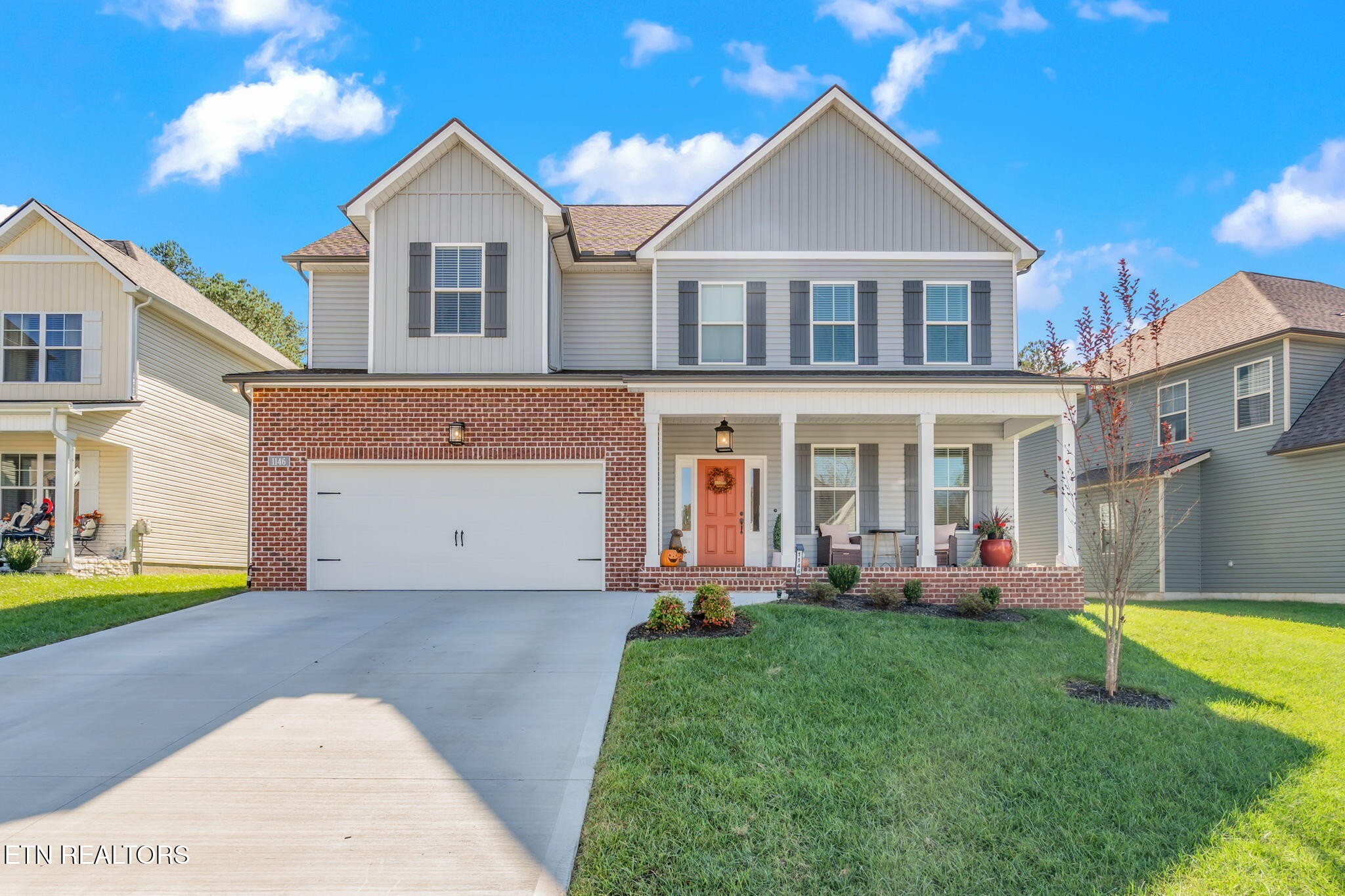 a front view of a house with a yard and entertaining space