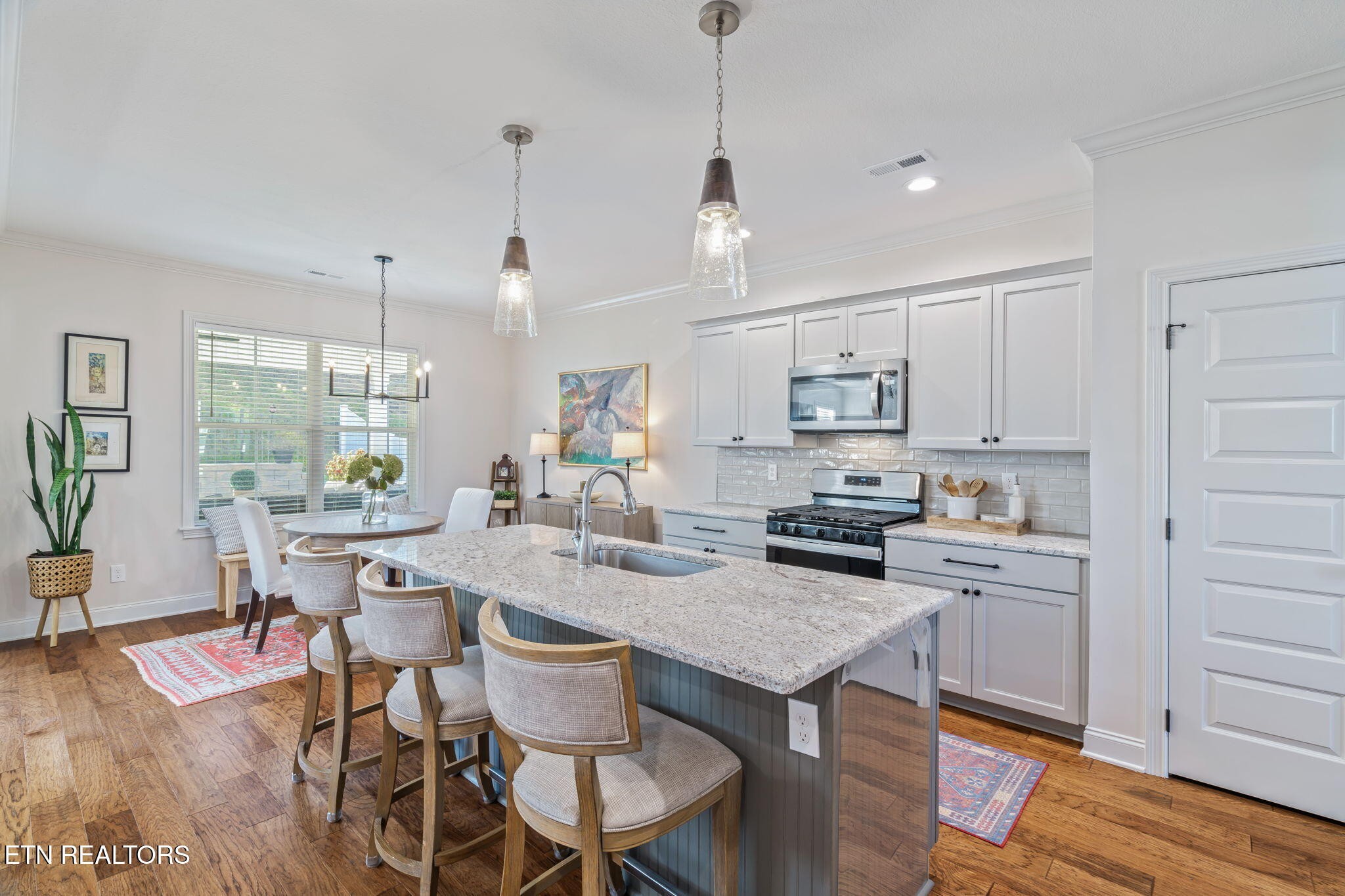 1146 Madison Oaks Road Knoxville, TN 37924 - Photo 11 of 48 a kitchen with a dining table chairs and wooden floor