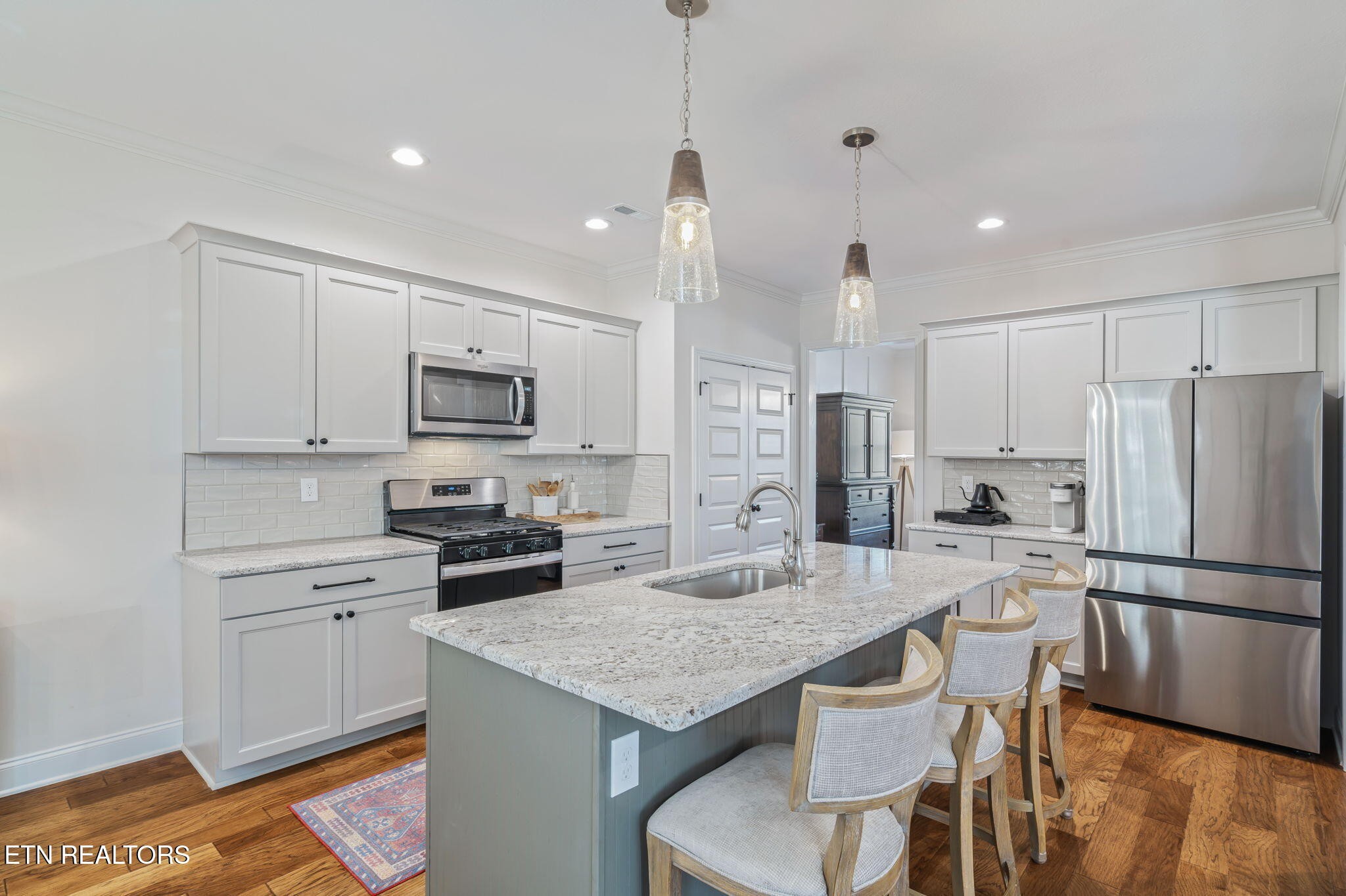 1146 Madison Oaks Road Knoxville, TN 37924 - Photo 12 of 48 a kitchen with kitchen island a refrigerator stove microwave and cabinets