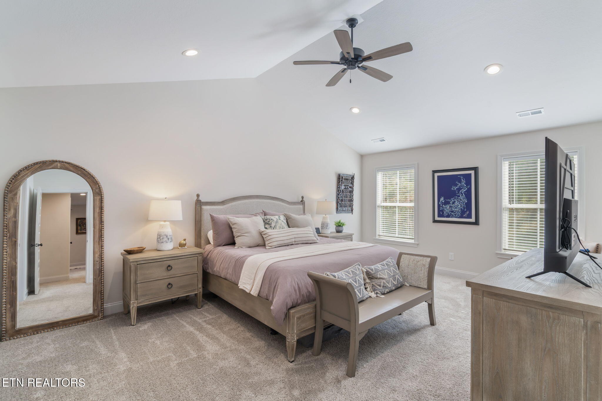 1146 Madison Oaks Road Knoxville, TN 37924 - Photo 23 of 48 a spacious bedroom with a bed a couch and a flat screen tv