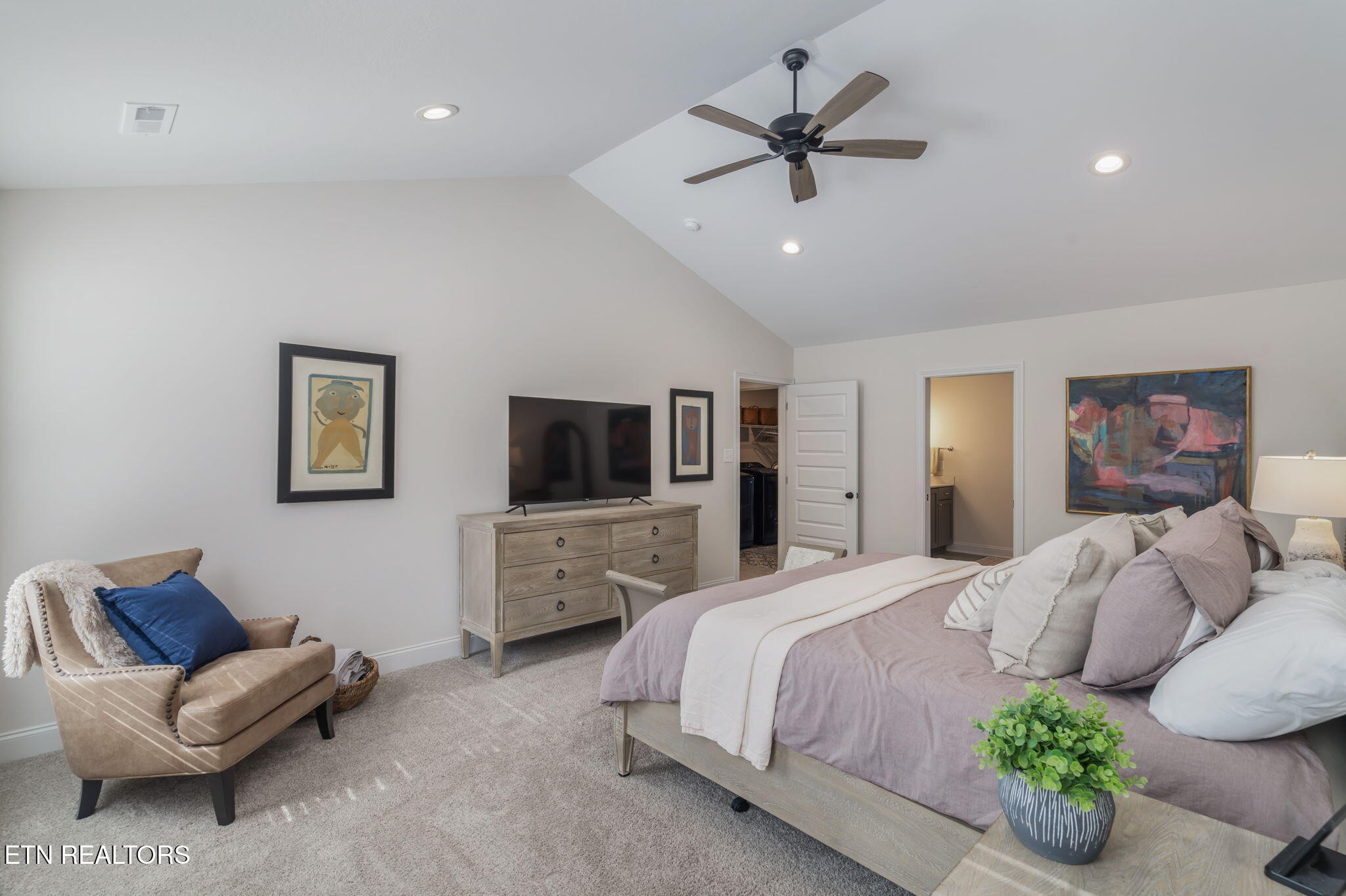 1146 Madison Oaks Road Knoxville, TN 37924 - Photo 24 of 48 a spacious bedroom with a bed a couch and a flat screen tv