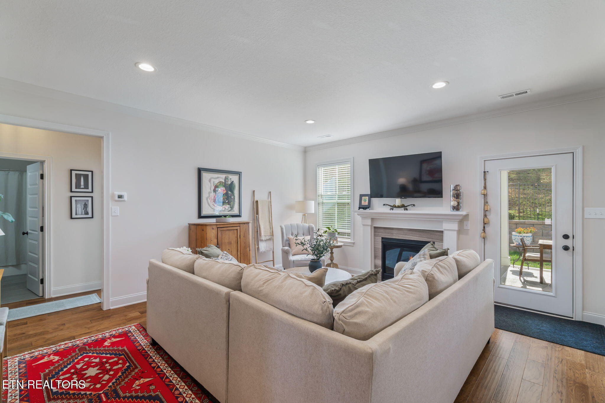 1146 Madison Oaks Road Knoxville, TN 37924 - Photo 9 of 48 a living room with furniture a flat screen tv and a fireplace