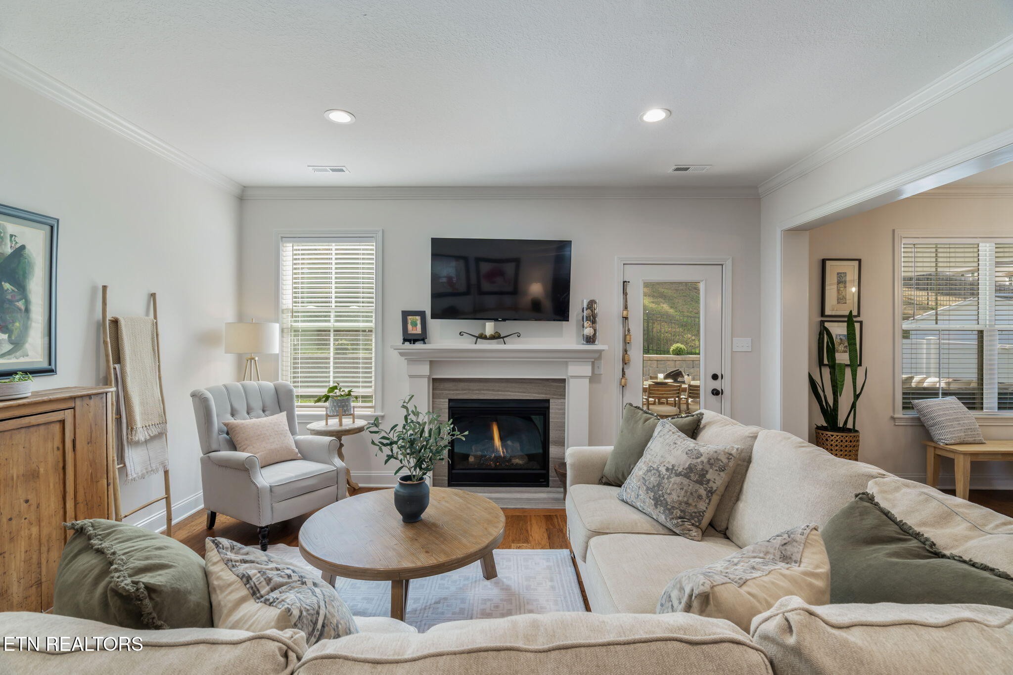 1146 Madison Oaks Road Knoxville, TN 37924 - Photo 10 of 48 a living room with furniture a fireplace and a flat screen tv