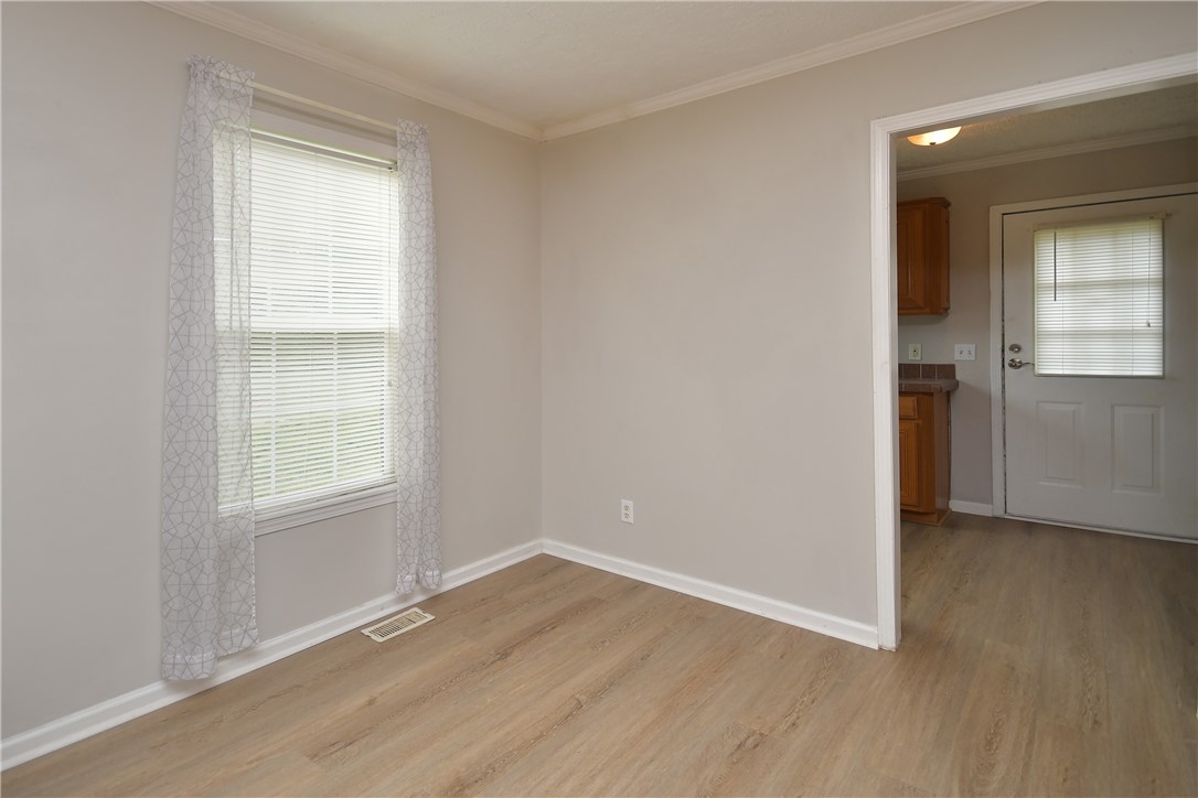 579 Daventon Road Honea Path, SC 29654 - Photo 20 of 44 A well-lit room featuring light wood flooring and a bright window with sheer curtains.