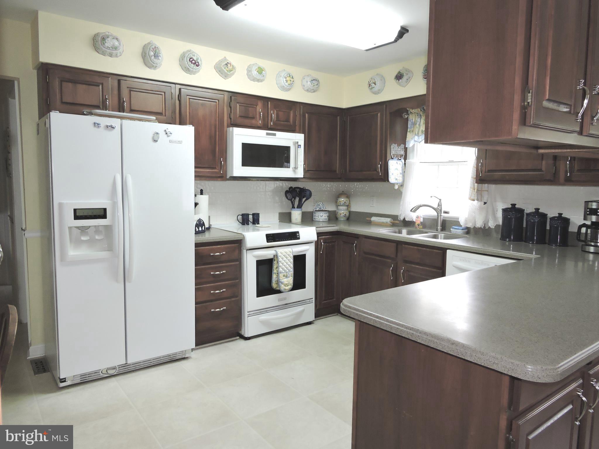 2758 Greene Lane Baldwin, MD 21013 - Photo 6 of 32 a kitchen with stainless steel appliances a refrigerator sink and cabinets