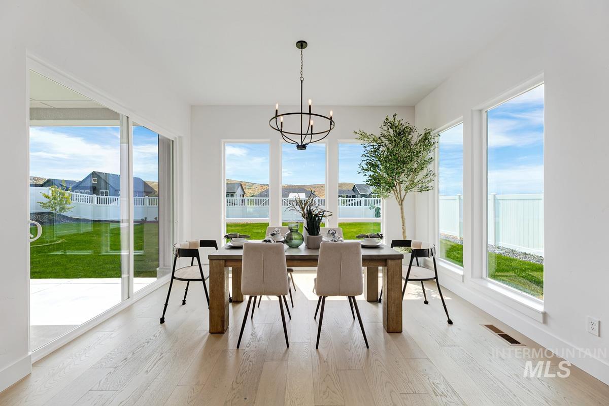 13339 North Hazel Grouse Way Boise, ID 83714 - Photo 13 of 50 Sunroom with healthy amount of natural light and hanging lights