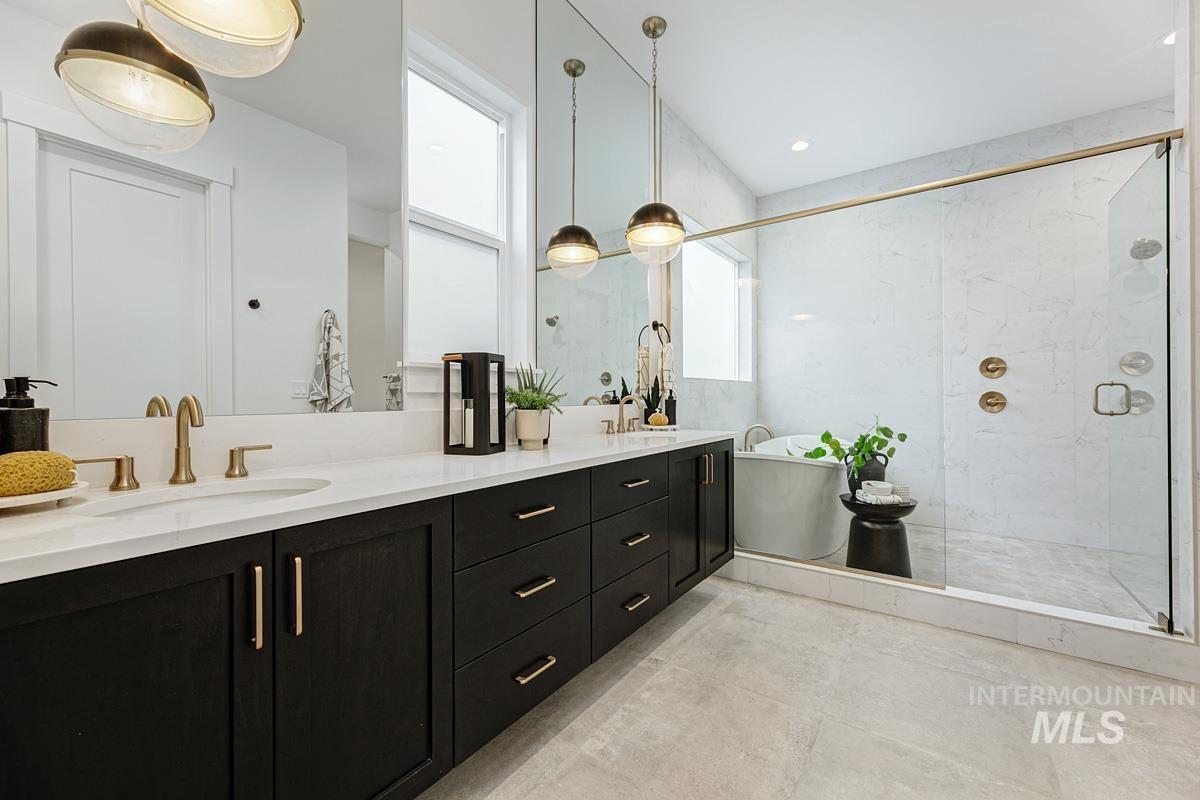 13339 North Hazel Grouse Way Boise, ID 83714 - Photo 18 of 50 Full bathroom with double vanity, a stall shower, and a freestanding tub