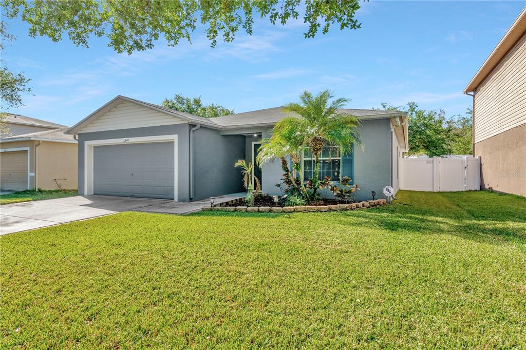 13644 Fareham Road Odessa, FL 33556 - Photo 1 of 1 a front view of a house with garden
