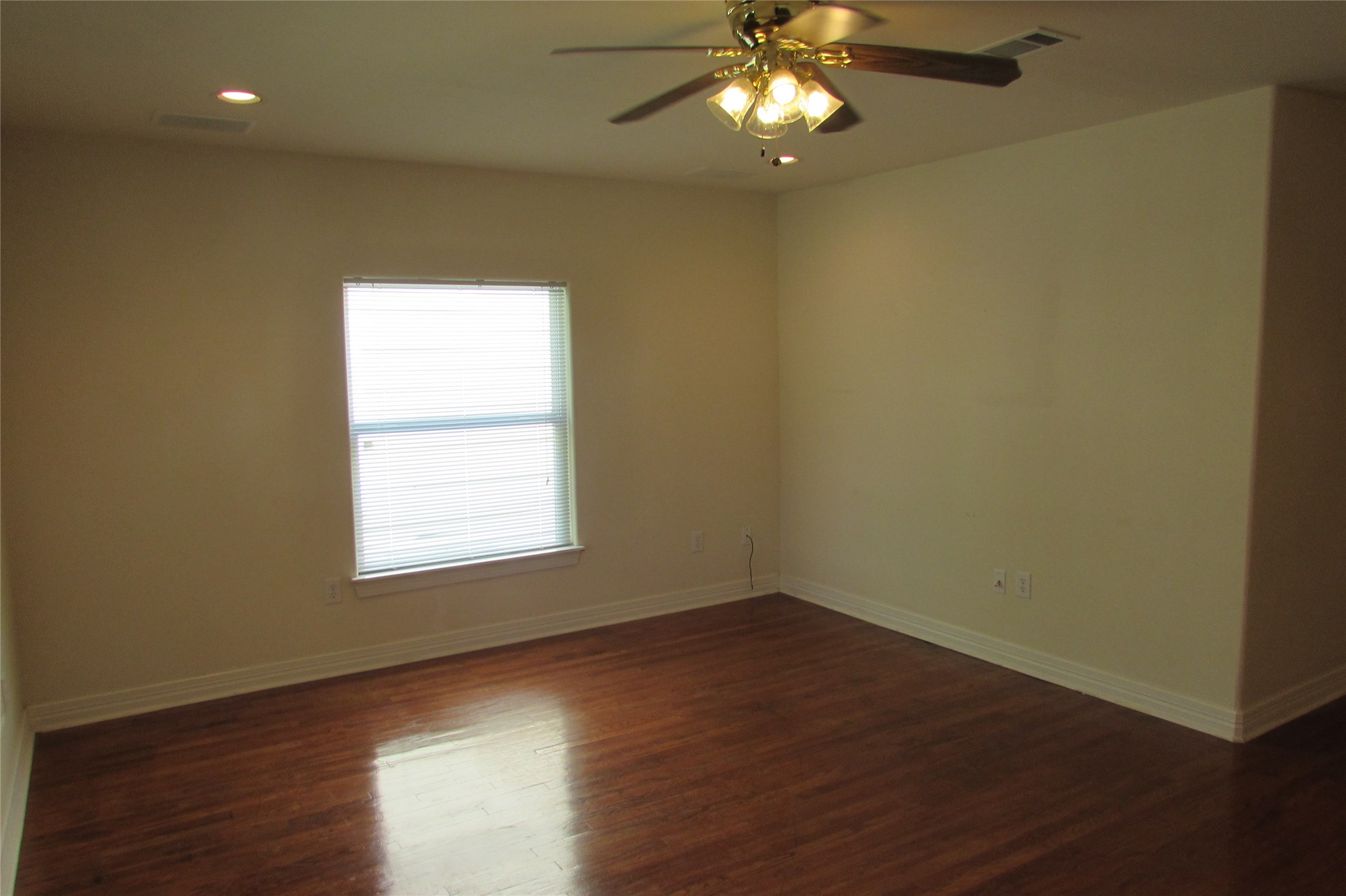 2513 Shakespeare Street, Unit 3 Houston, TX 77030 - Photo 5 of 15 an empty room with wooden floor and windows