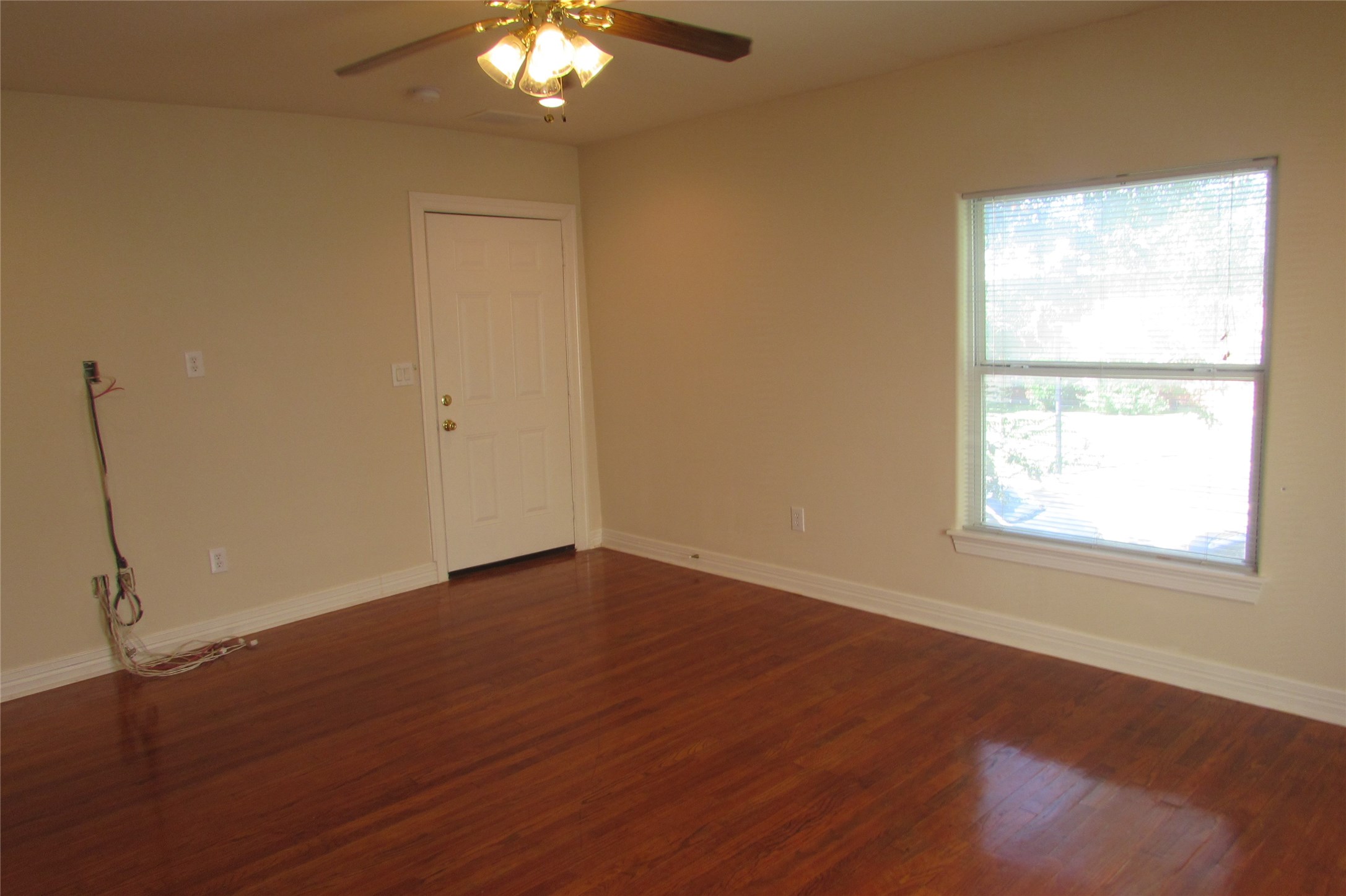 2513 Shakespeare Street, Unit 3 Houston, TX 77030 - Photo 6 of 15 an empty room with wooden floor and windows