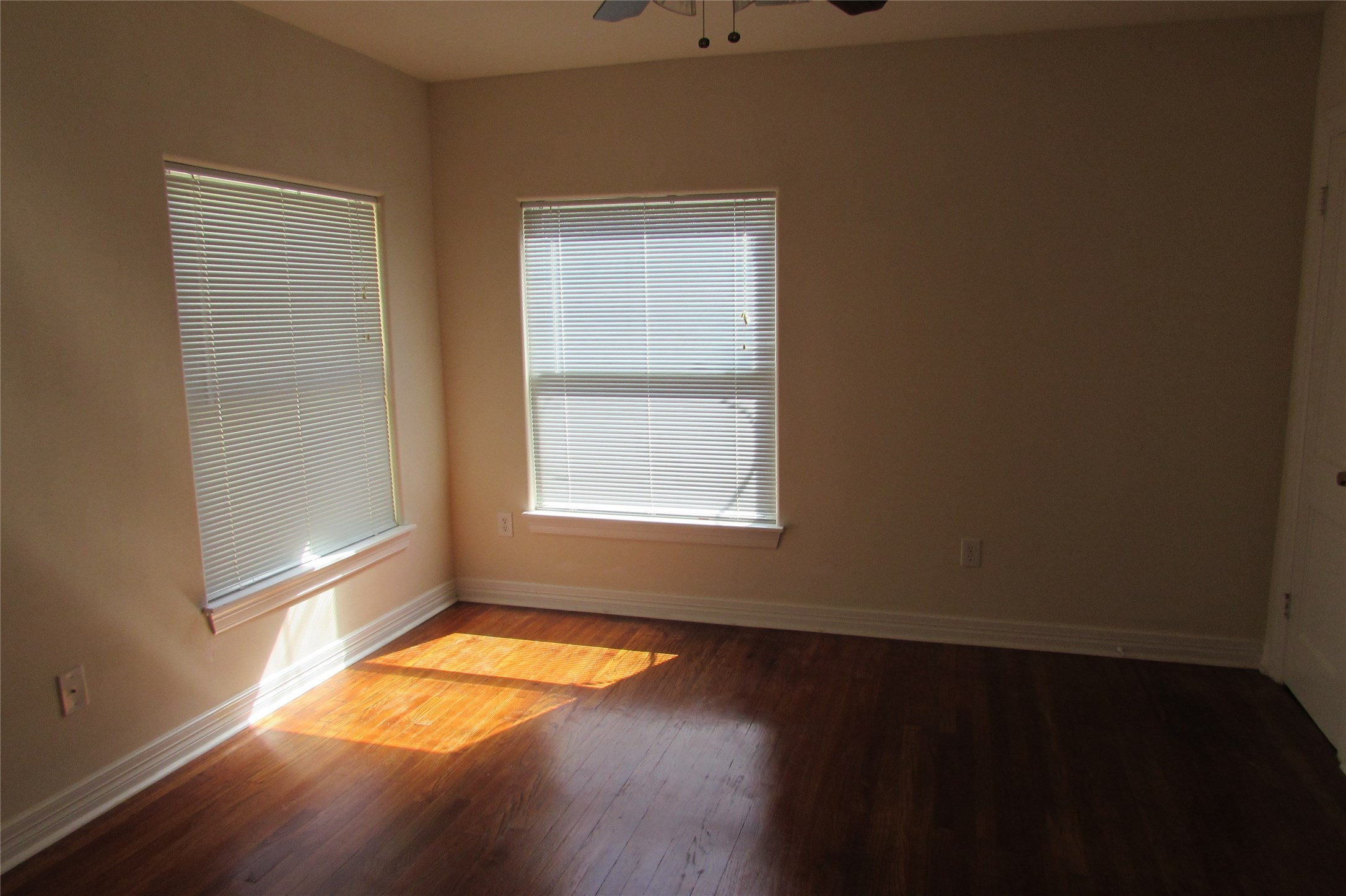 2513 Shakespeare Street, Unit 3 Houston, TX 77030 - Photo 9 of 15 an empty room with wooden floor and windows