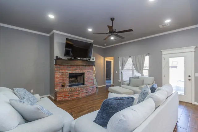 a living room with furniture a fireplace and a flat screen tv