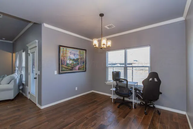 a workspace with wooden floor and a window