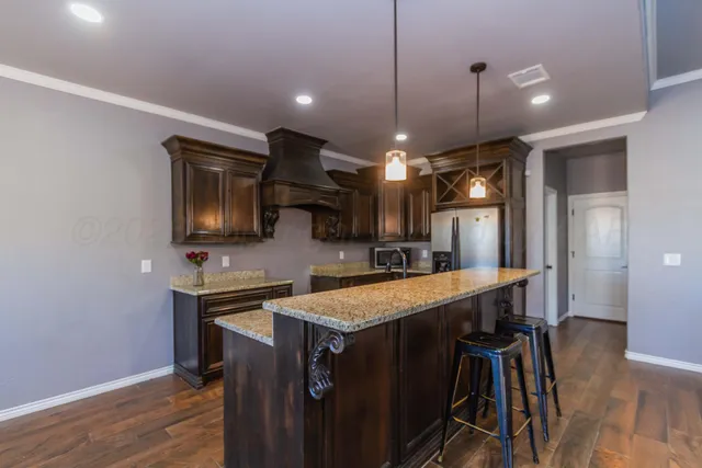 a large kitchen with a table and chairs