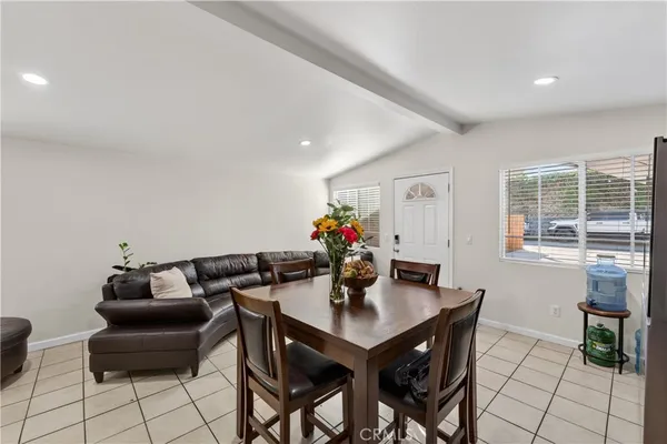 a view of a dining room with furniture and a potted plant