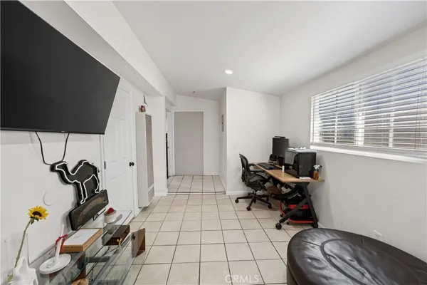 a view of a workspace with furniture and a window