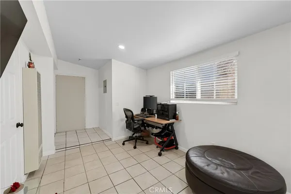 a view of a workspace with furniture and a window