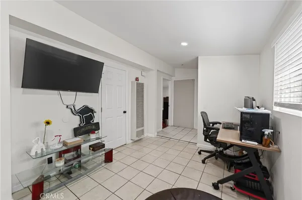 a view of a workspace with furniture and a window